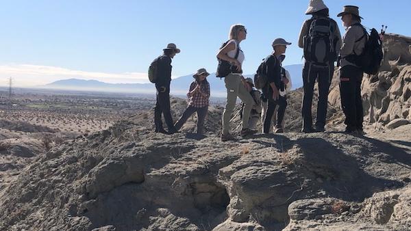 Naturalists standing on a desert mountain