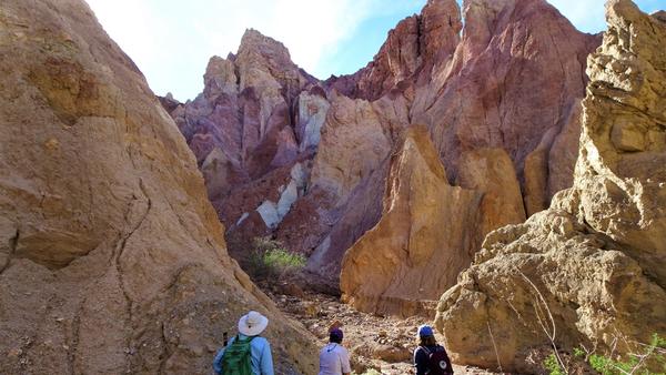 Three people hiking through Mecca Hills 