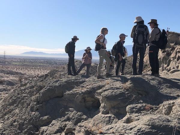 Naturalists standing on a desert mountain