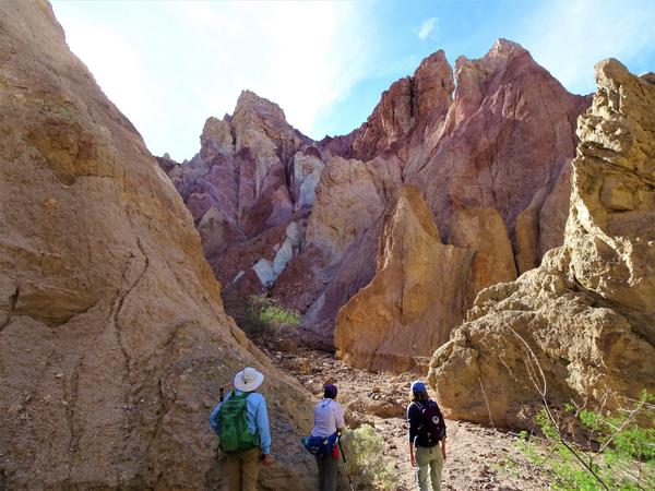 Three people hiking through Mecca Hills 