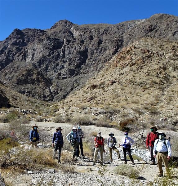 Masked community scientists standing in Deep Canyon