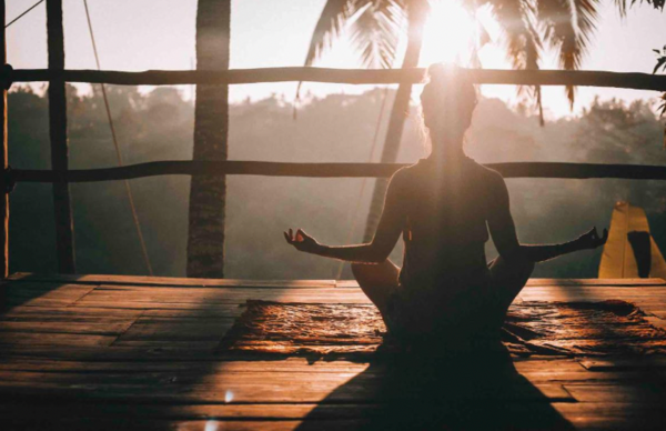 A person doing yoga on a beautiful balcony 